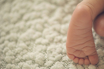 Small delicate little feet of newborn