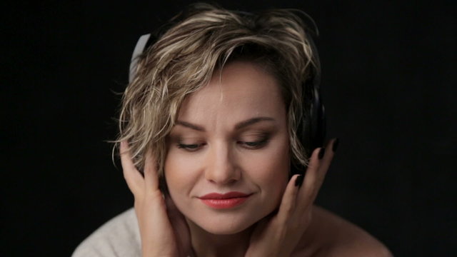 Woman blonde closeup listening to music.