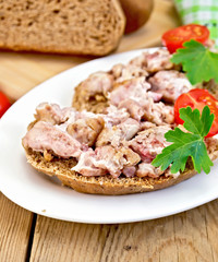 Sandwich with brains in oval plate on board