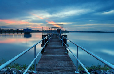 Fototapeta premium The long bridge toward to pump house at reservoir ,Thailand