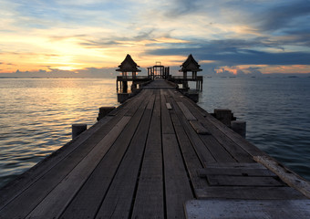 Obraz na płótnie Canvas The long bridge over the sea with a beautiful sunrise, Thailand