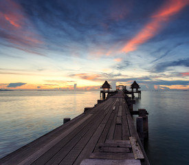 Obraz na płótnie Canvas The long bridge over the sea with a beautiful sunrise, Thailand