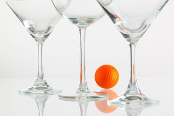 Three glasses of champagne and golf equipments