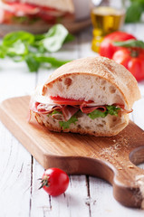 Italian focaccia with tomato, prosciutto and mozzarella