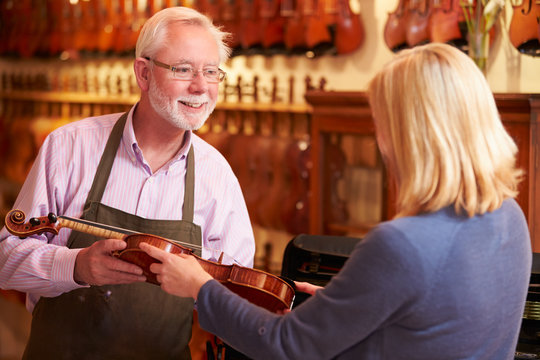 Customer Leaving Violin For Repair In Shop