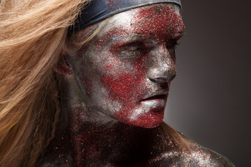 woman in silver paint and red powder