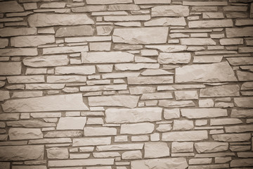 A dry stone wall made of random grey stone. wall of stones 