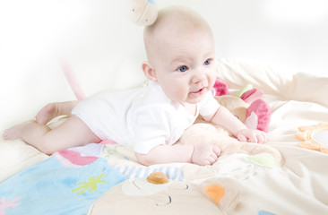 baby girl lying down on playing mat