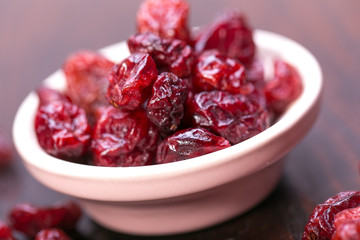 dried cranberries in a wooden spoon. fruit full of vitamin c. 