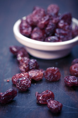 dried cranberries in a wooden spoon. fruit full of vitamin c. 