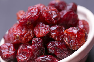 dried cranberries in a wooden spoon. fruit full of vitamin c. 