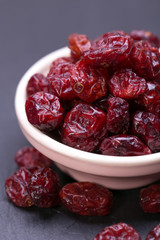dried cranberries in a wooden spoon. fruit full of vitamin c. 