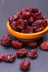 dried cranberries in a wooden spoon. fruit full of vitamin c. 