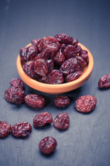 dried cranberries in a wooden spoon. fruit full of vitamin c. 