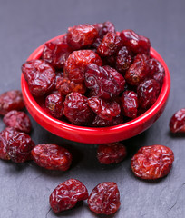 dried cranberries in a wooden spoon. fruit full of vitamin c. 