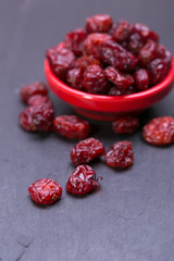 dried cranberries in a wooden spoon. fruit full of vitamin c. 