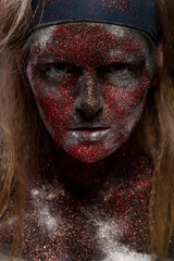 woman in silver paint and red powder