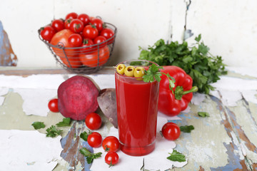 Glass of tomato juice and fresh vegetables