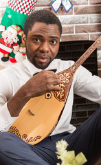 African American man with Musical instrument Dombra