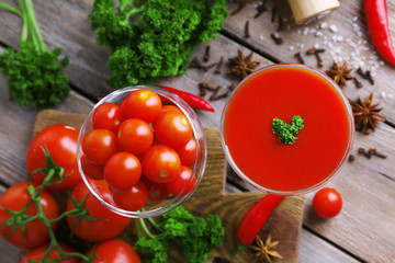 Tomato juice in goblet and fresh vegetables