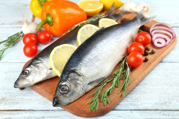 Fresh raw fish and food ingredients on table