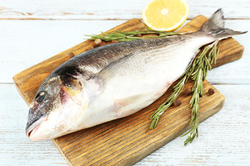 Fresh raw fish and food ingredients on table