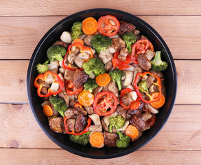 Braised wild mushrooms with vegetables and spices in pan