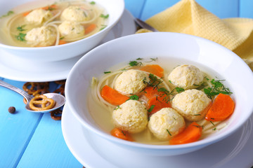 Soup with meatballs and noodles in bowls