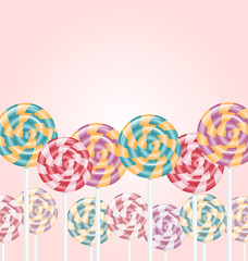 Multicolored lollipops on pink background