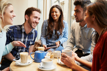 Group Of Friends In Caf‚ Using Digital Devices