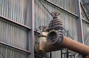 The flanges and old metal constructions in industrial zone © northernland