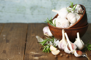 Raw garlic and spices on wooden table