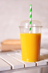 Orange juice in fast food closed cup with tube