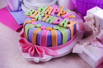 Delicious birthday cake on table close-up