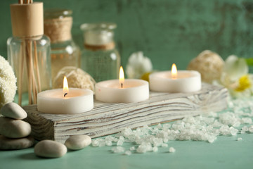Composition of spa treatment, candles in bowl with water