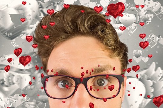 Composite image of geeky businessman looking at camera