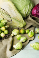 Still life with assortment cabbages on wooden background