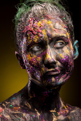 Girl with colorful make-up posing in dark