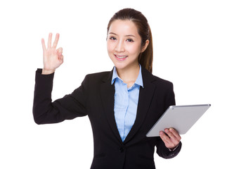 Businesswoman use of tablet and ok sign