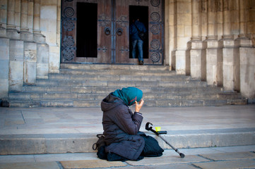 Mendicant begging outside a church
