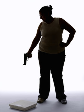 Young woman shooting at a scale