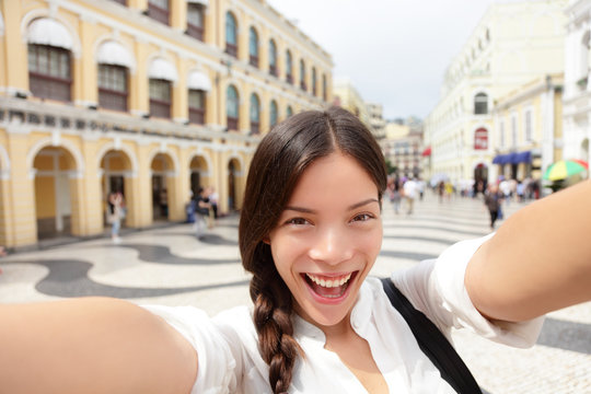 Selfie woman taking fun selfportrait in Macau