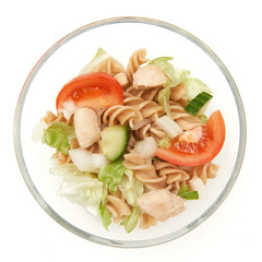 Pasta salad with chicken in a glass bowl