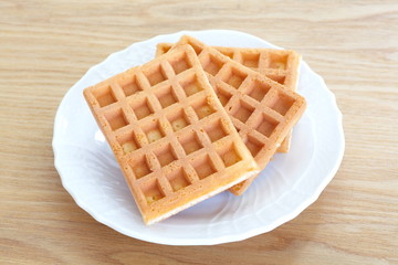 Delicious sweet waffle in ceramic plate on white plate