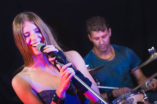 Man and Woman Playing and Singing Rock Music