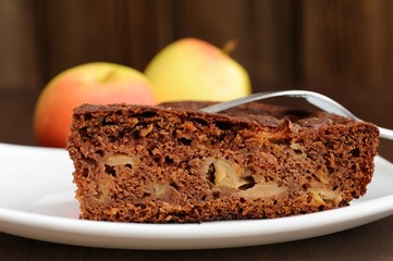 Piece of chocolate apple cake and apples