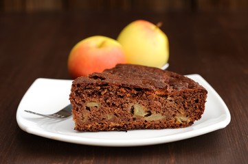 Piece of chocolate apple cake and apples