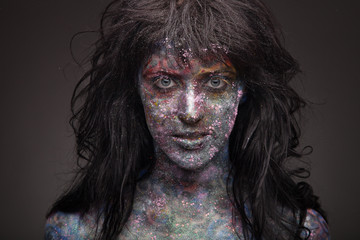 girl in paint and neon powder with glitter