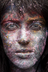 girl in paint and neon powder with glitter