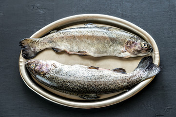 Fresh trouts in ice on the vintage metal tray